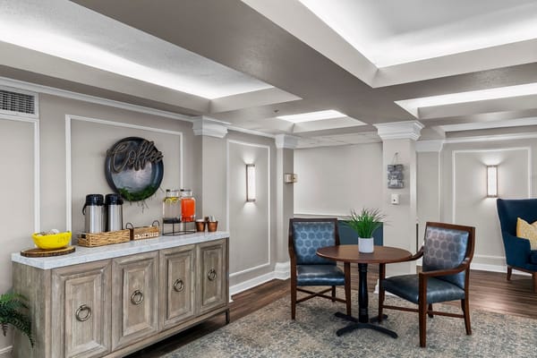 Cozy coffee station with chairs and tables in a senior living facility