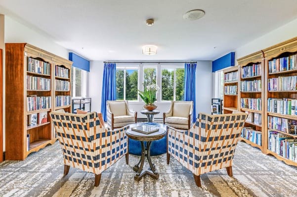 Well-lit reading nook with bookshelves and seating