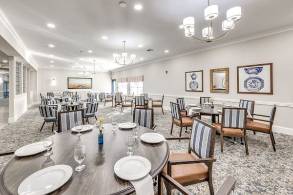 Spacious dining room with tables set for a meal