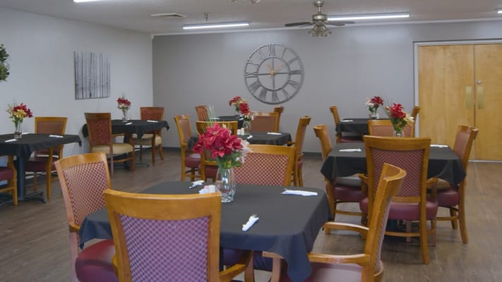 Dining area with tables set for residents