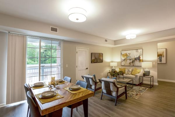 Bright and spacious living room with dining area, large windows, and modern decor