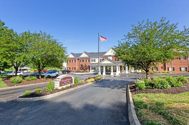 Entrance view of StoryPoint Knoxville West with American flag and landscaped grounds