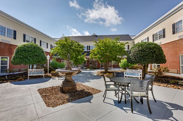Outdoor courtyard with fountain and seating area