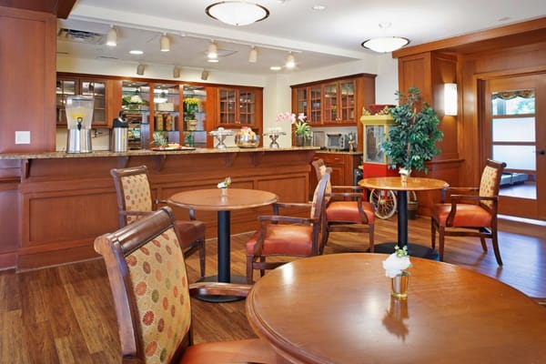 Inviting common area with tables and chairs in a senior living facility