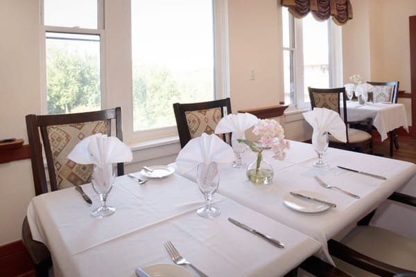 Elegant dining table with folded napkins and floral centerpiece