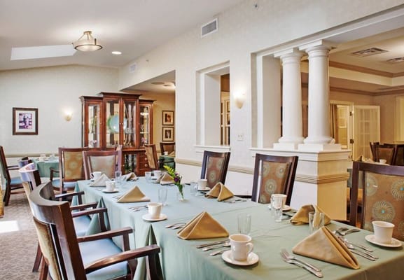 Dining table set with plates and napkins in the dining room