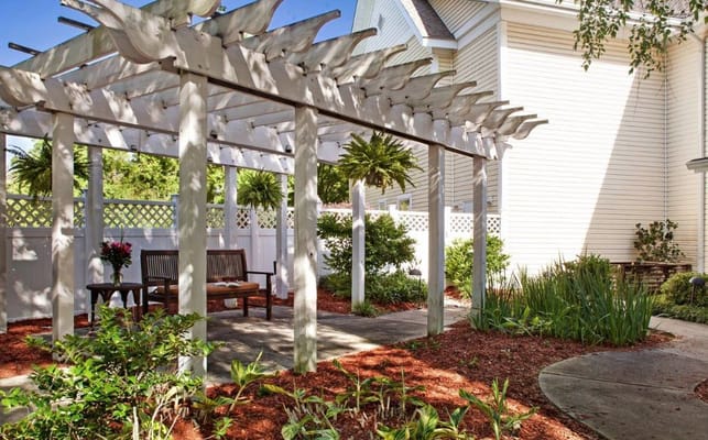 Outdoor seating area with garden and pergola