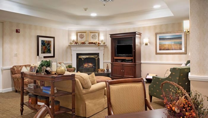 A cozy common area with seating and fireplace
