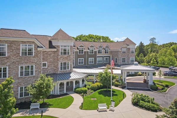 Exterior view of a senior living facility with gardens