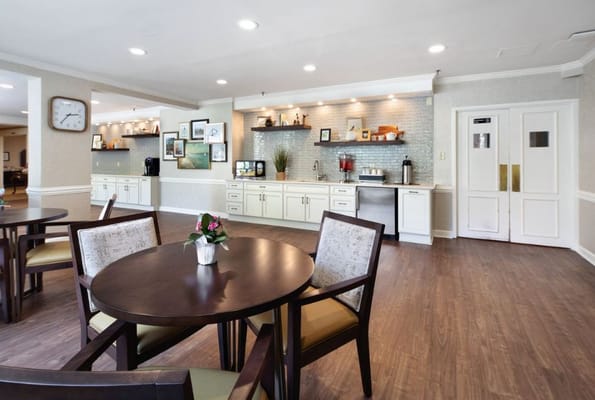 Bright common area with tables and kitchenette