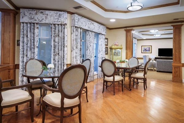 Dining area with tables and seating in a senior living facility