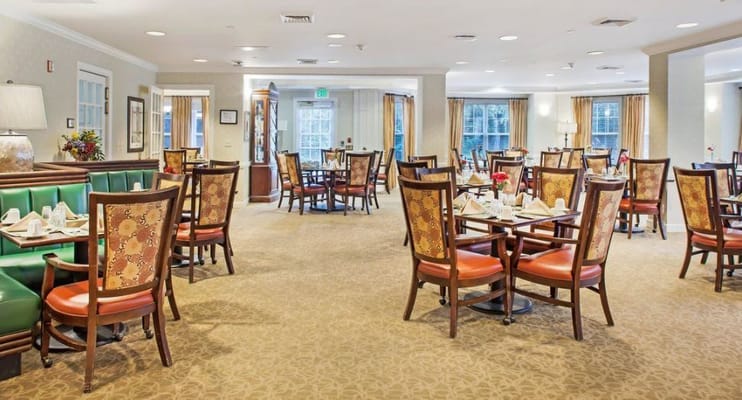 Bright dining room with tables set for meals
