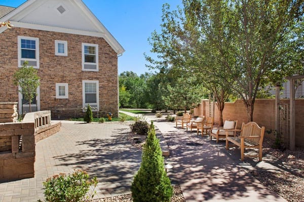 Outdoor garden with seating area and paved pathway
