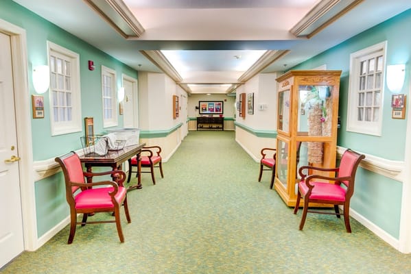A serene hallway featuring chairs and decorative elements.