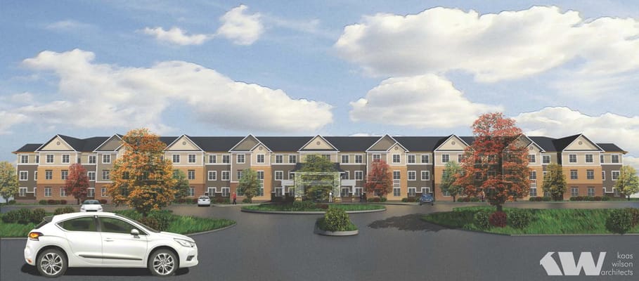 Exterior view of a senior living facility with surrounding landscape