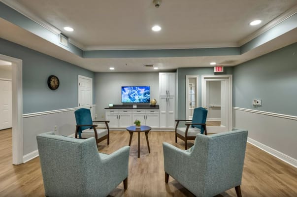 Interior seating area with chairs and television