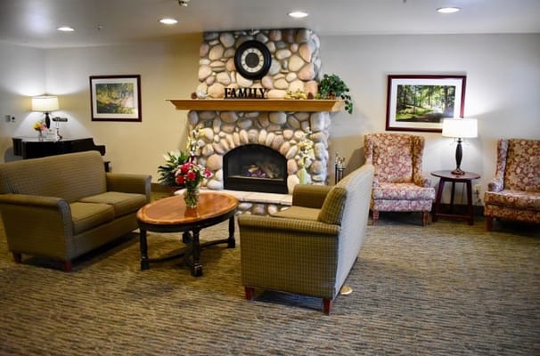 A comfortable living room with a fireplace and seating areas.