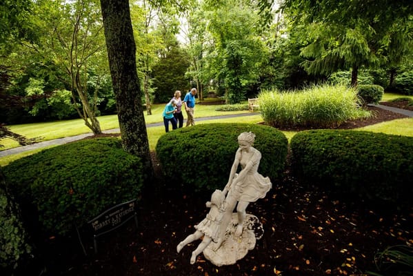 Three residents enjoying a walk in the garden