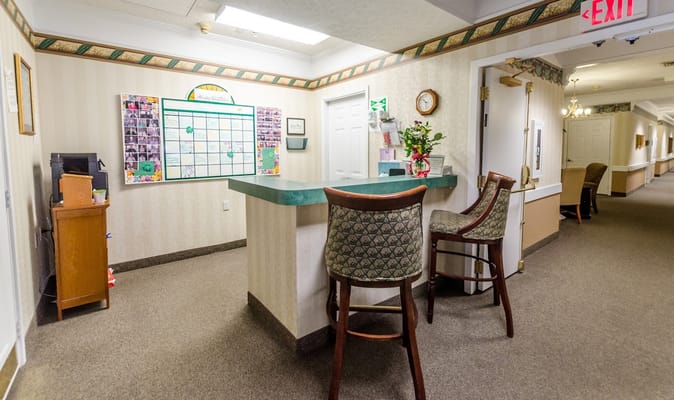 Lobby reception area with green counter and bulletin board.