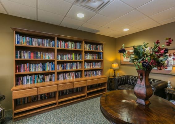 Interior view of a library with bookshelves and comfortable seating