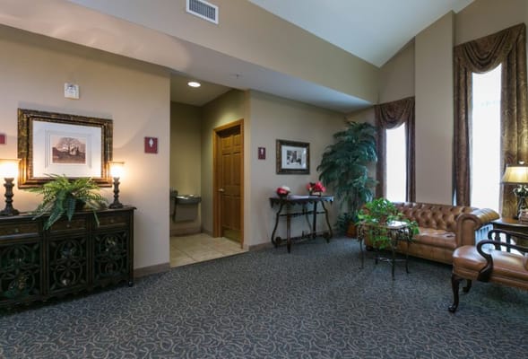Cozy lobby area with a couch and decorative plants