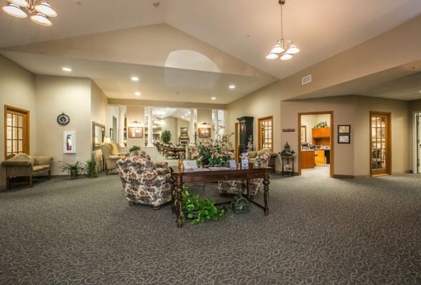 Warm and inviting lobby area with floral seating and a reception desk.