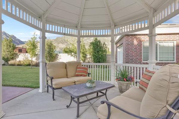Comfortable seating area in a gazebo with a table and cushions