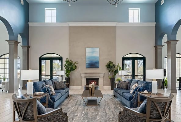 Modern living room with comfortable seating, fireplace, and decorative plants