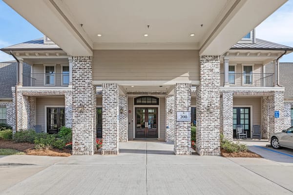Main entrance of The Claiborne at Hattiesburg featuring brick columns and doorway.