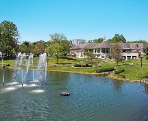 Pond with fountains in front of The Fairfax senior living facility