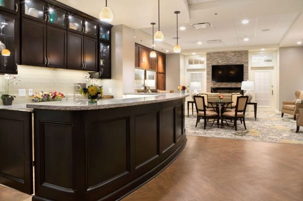 Inviting lounge area with seating and a kitchen-like bar.
