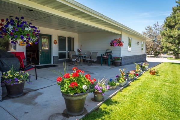 Outdoor entrance with colorful flower pots and seating