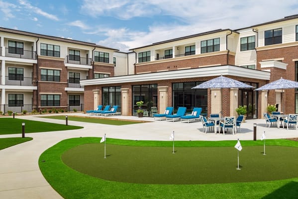 Outdoor space with seating and putting green