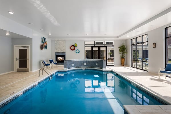 Indoor swimming pool area with seating