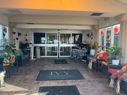 Entrance area decorated with autumn-themed decor and plants