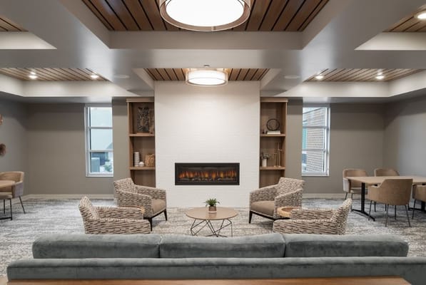 Cozy lounge with seating and a fireplace