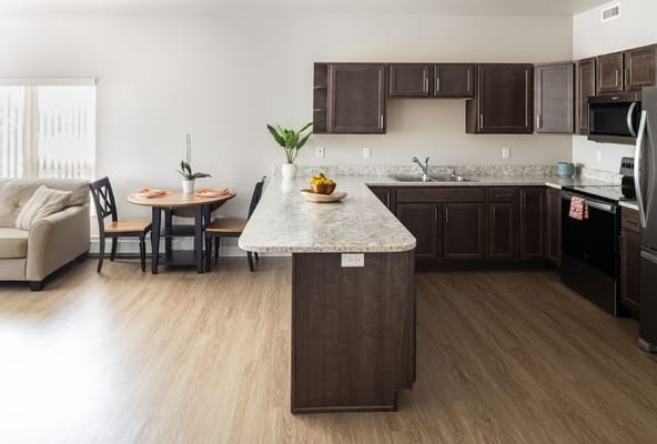 Modern kitchen with dining table and cozy seating area.