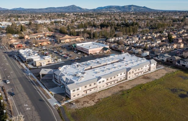 Aerial view of The Lodge at Piner Road surrounded by local businesses and residences.