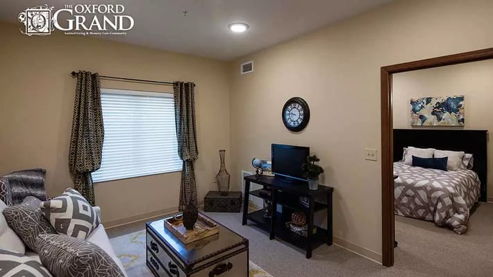 Cozy living area with a view and adjoining bedroom.