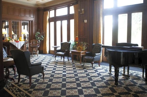 Cozy lounge with seating and a piano