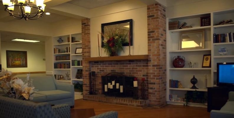 Inviting living room with a fireplace and bookshelves.