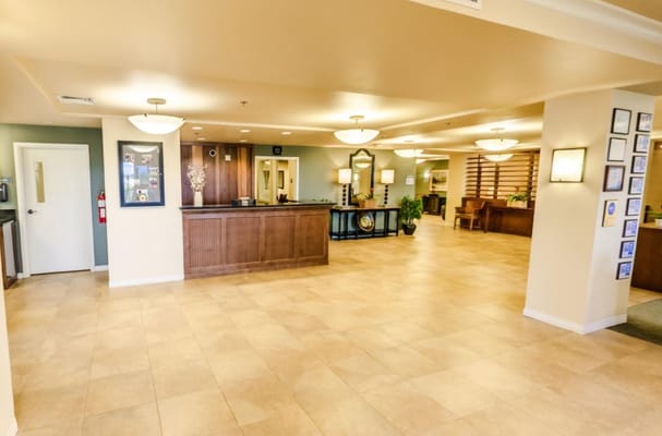 Spacious lobby area with a reception desk and seating