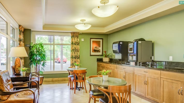 Cozy lounge area with seating and a coffee station