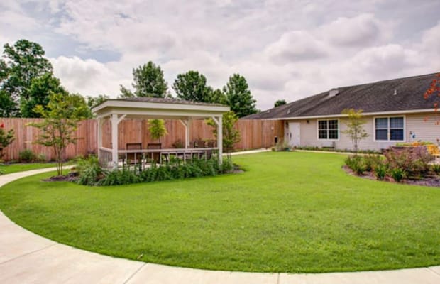 Spacious outdoor garden with a covered seating area.