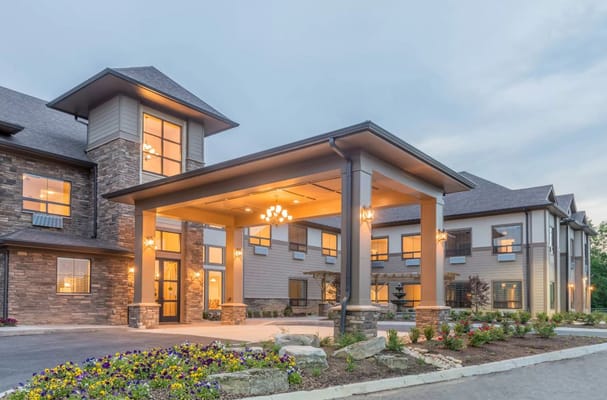 Exterior view of The Pointe at Lifespring with a covered entrance and landscaped area