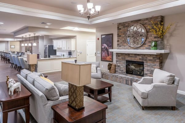 Cozy living room with seating and fireplace.