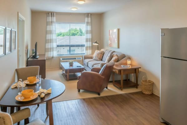 Bright living room with seating area and dining table