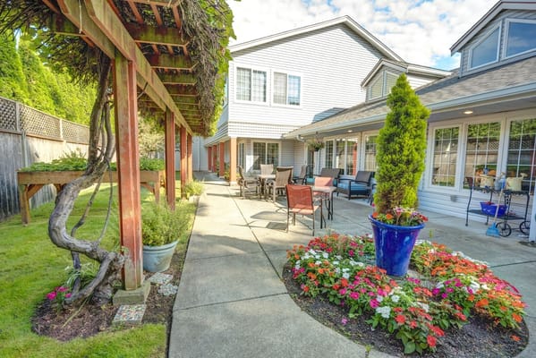 Serene outdoor garden area with flowers and seating