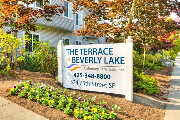 Sign for The Terrace at Beverly Lake with flowers in front