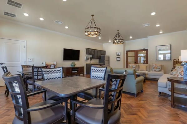 Spacious common area with seating and dining tables